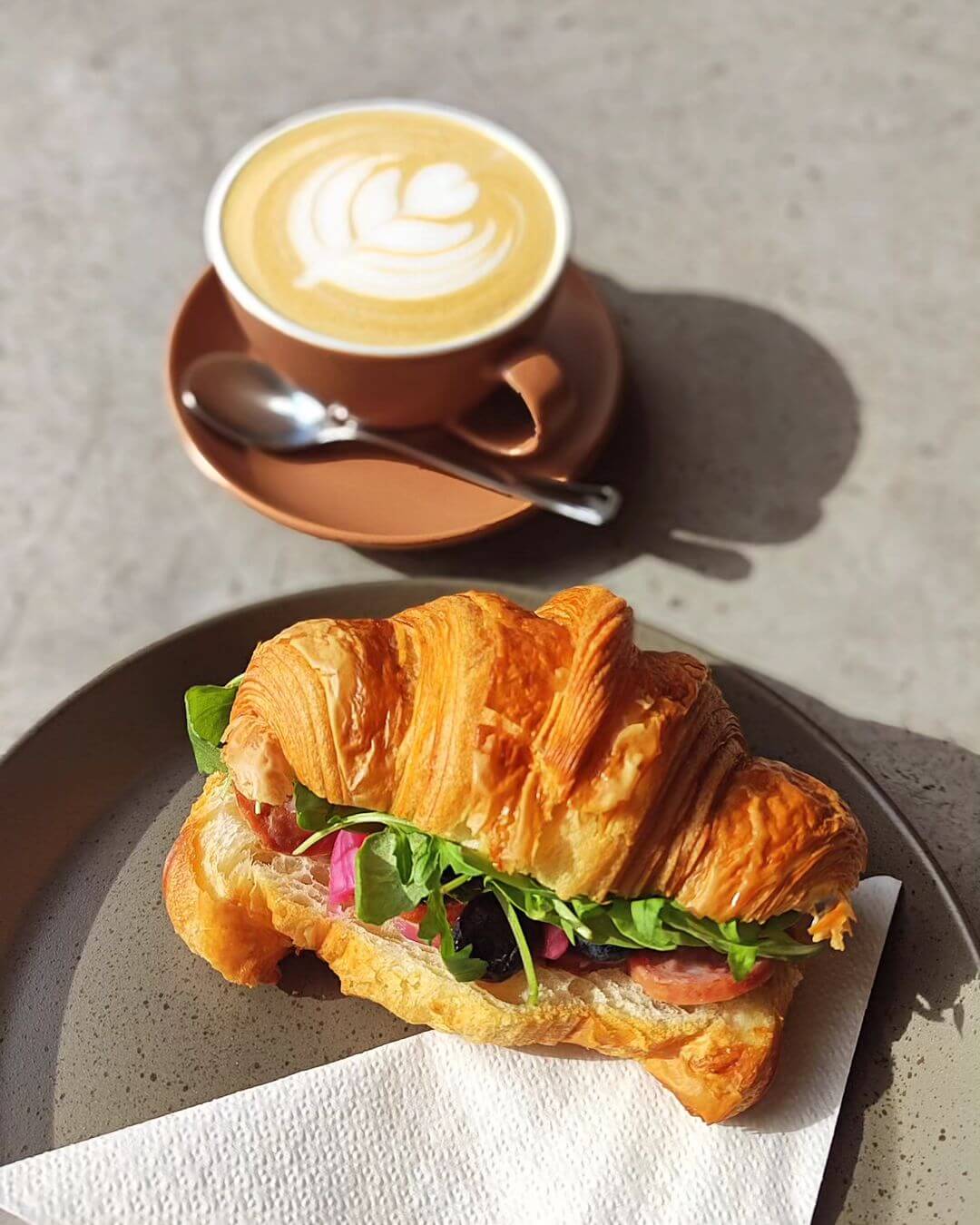 Rafinerija Cukrarna coffee and croissant